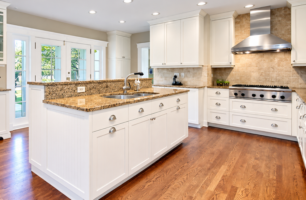 Bright white kitchen with custom cabinets, granite countertops, stainless steel range hood, and hardwood flooring